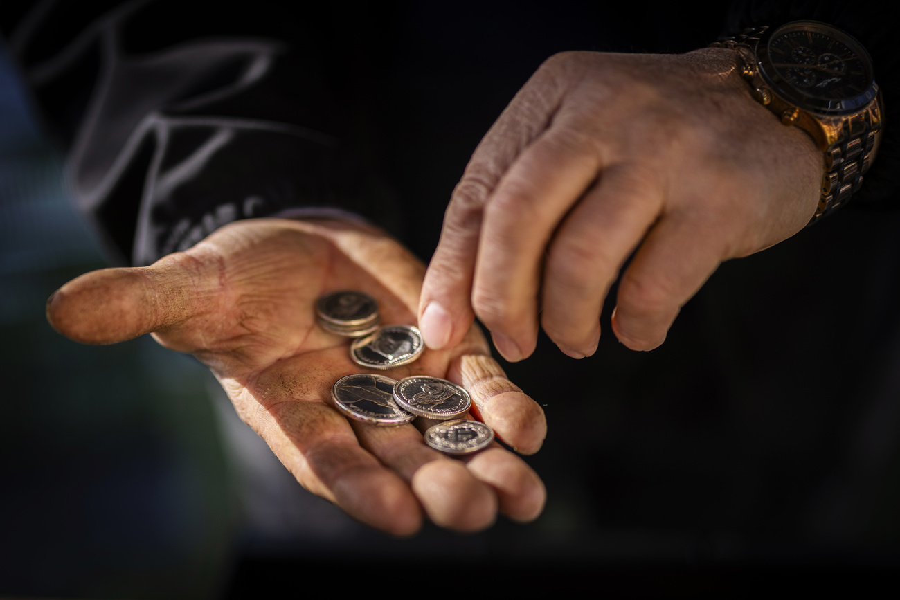 man with coins in hand