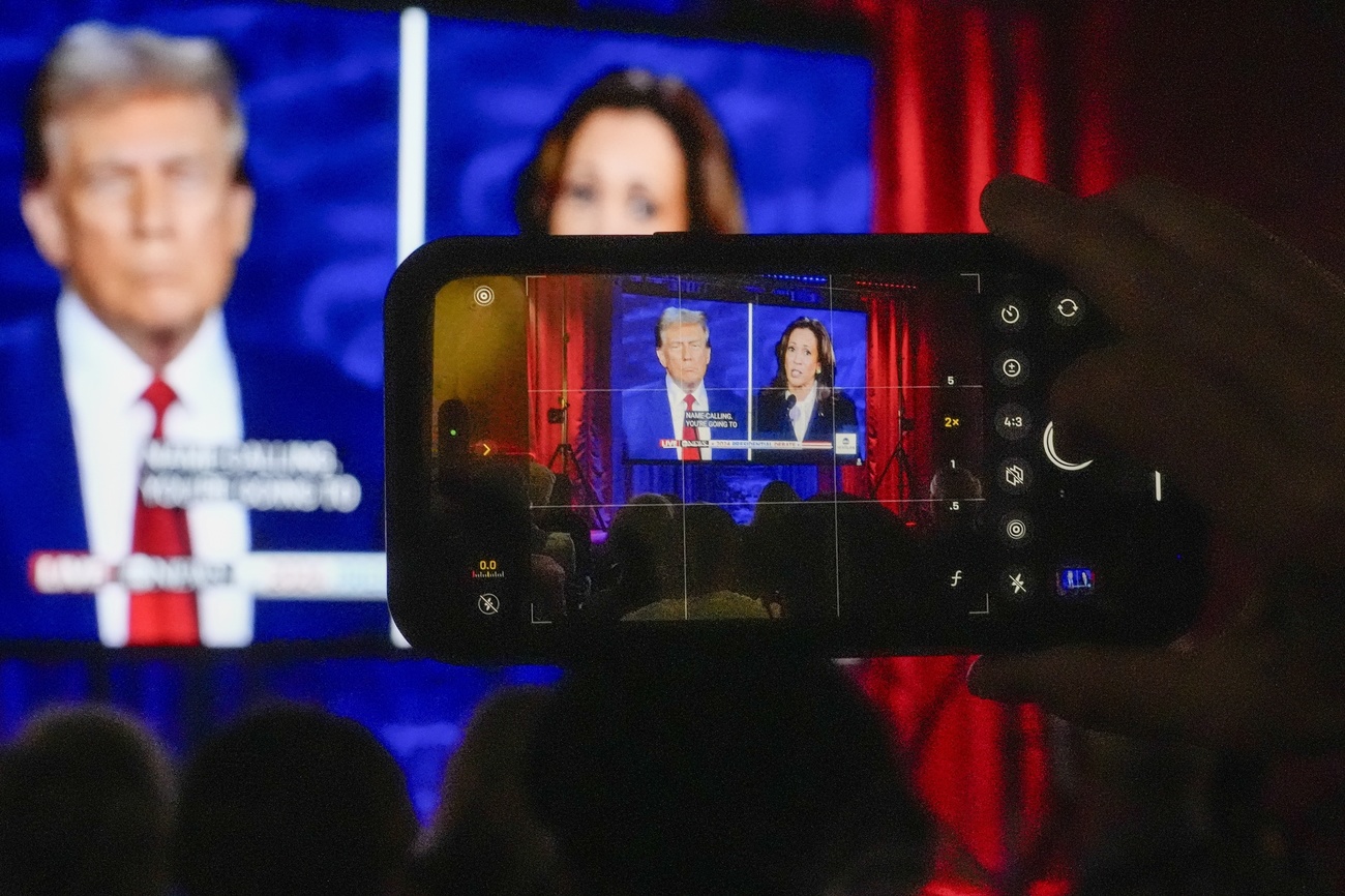 People gather at No Studios to watch the presidential debate between Republican presidential nominee former President Donald Trump and Democratic presidential nominee Vice President Kamala Harris, Tuesday, Sept. 10, 2024, in Milwaukee. (AP Photo/Morry Gash)