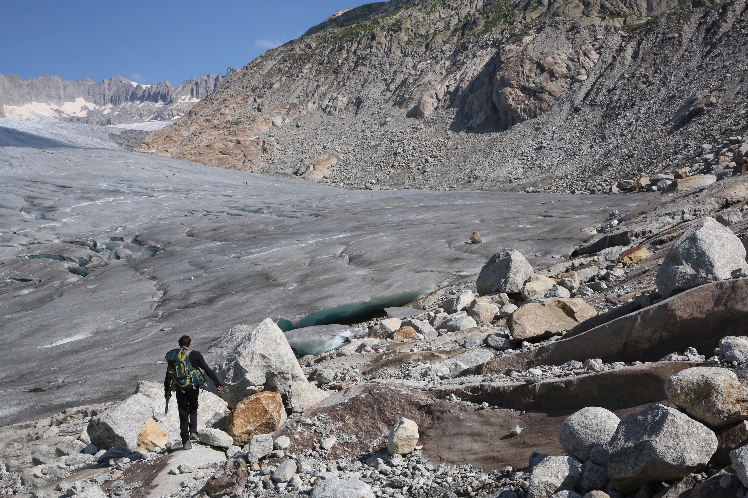 Ein Mann läuft einem Gletscher entlang