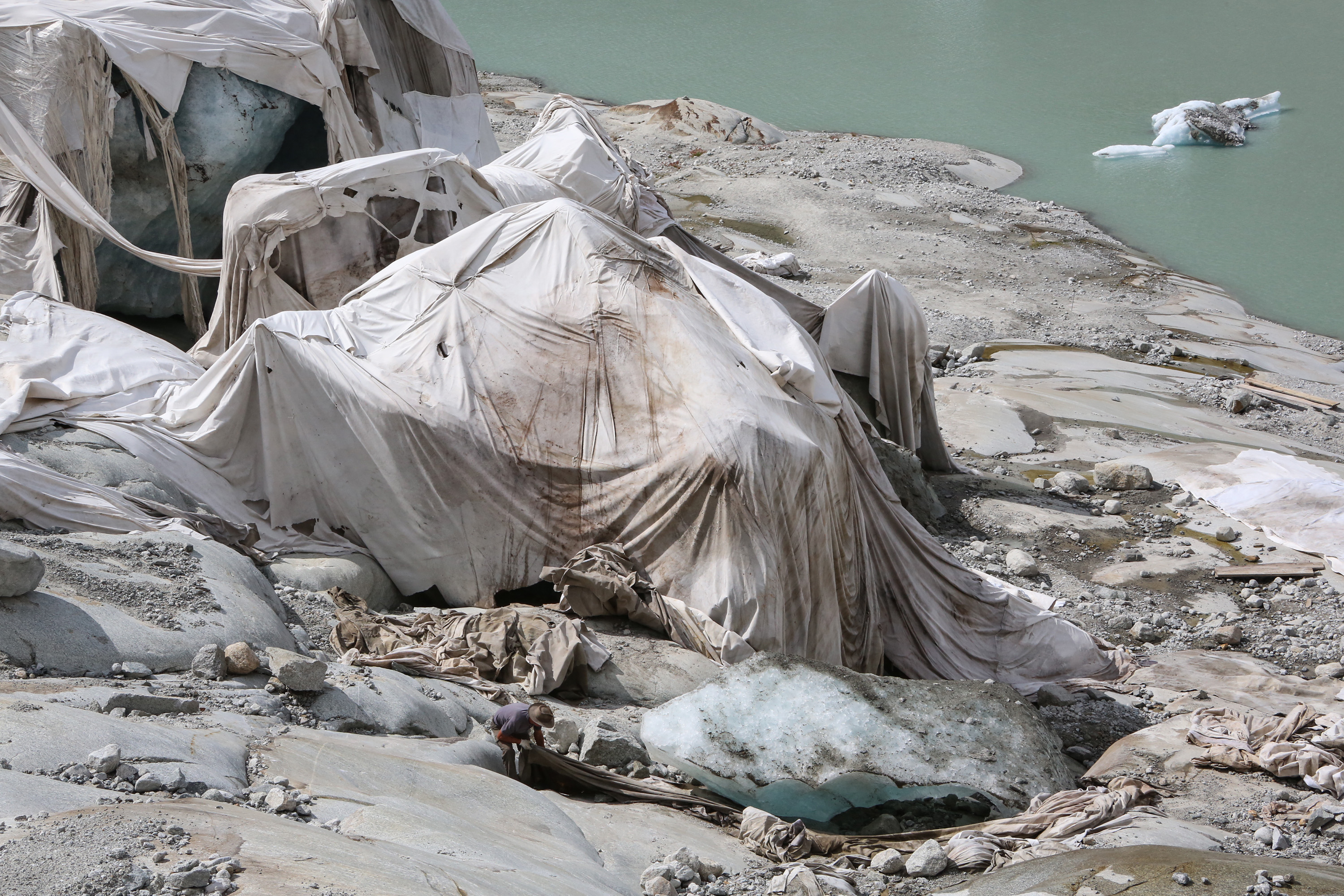 White geotextile sheets protect the ice cave from the sun's rays.