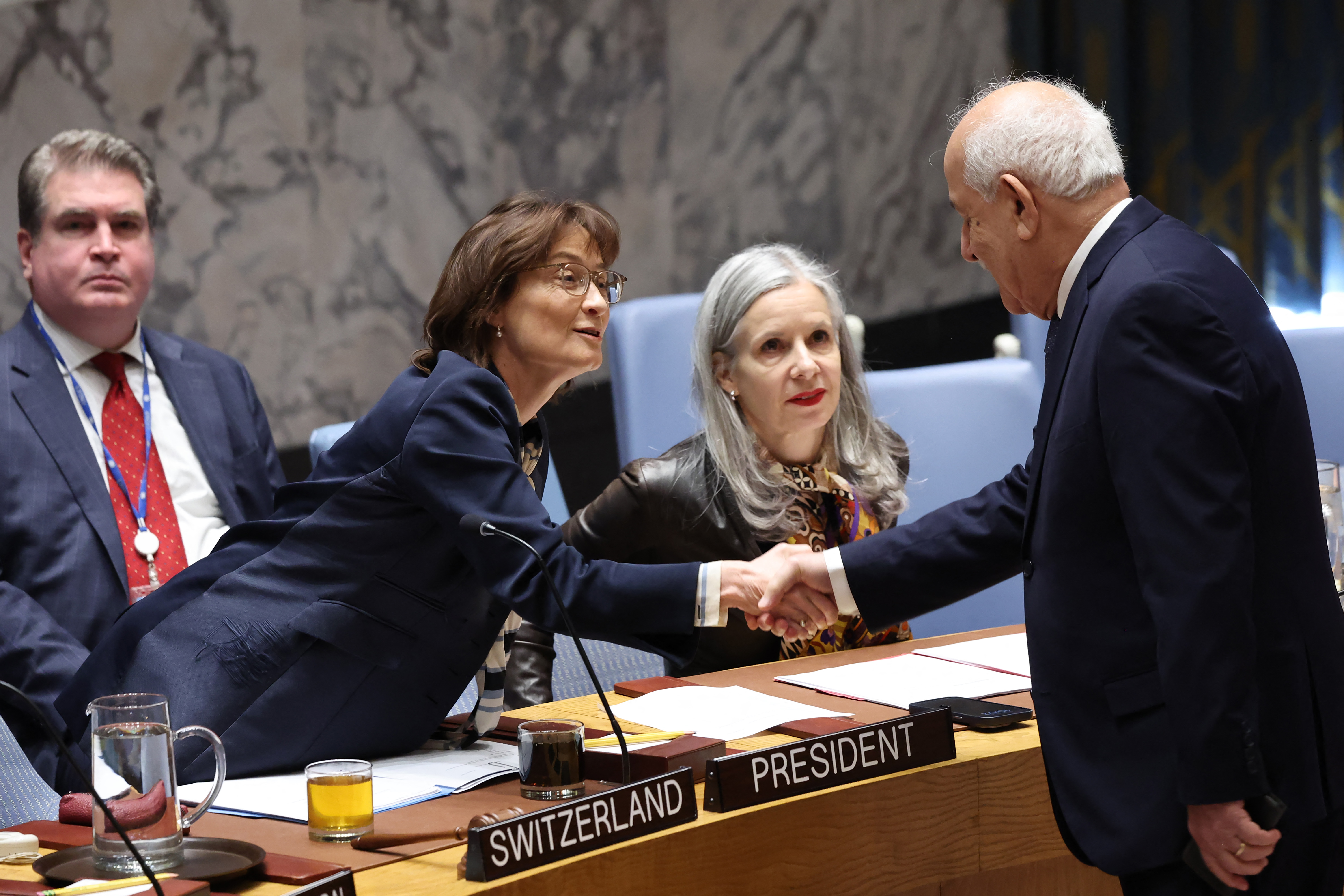 Pascale Baeriswyl shakes hands with Riyad Mansour