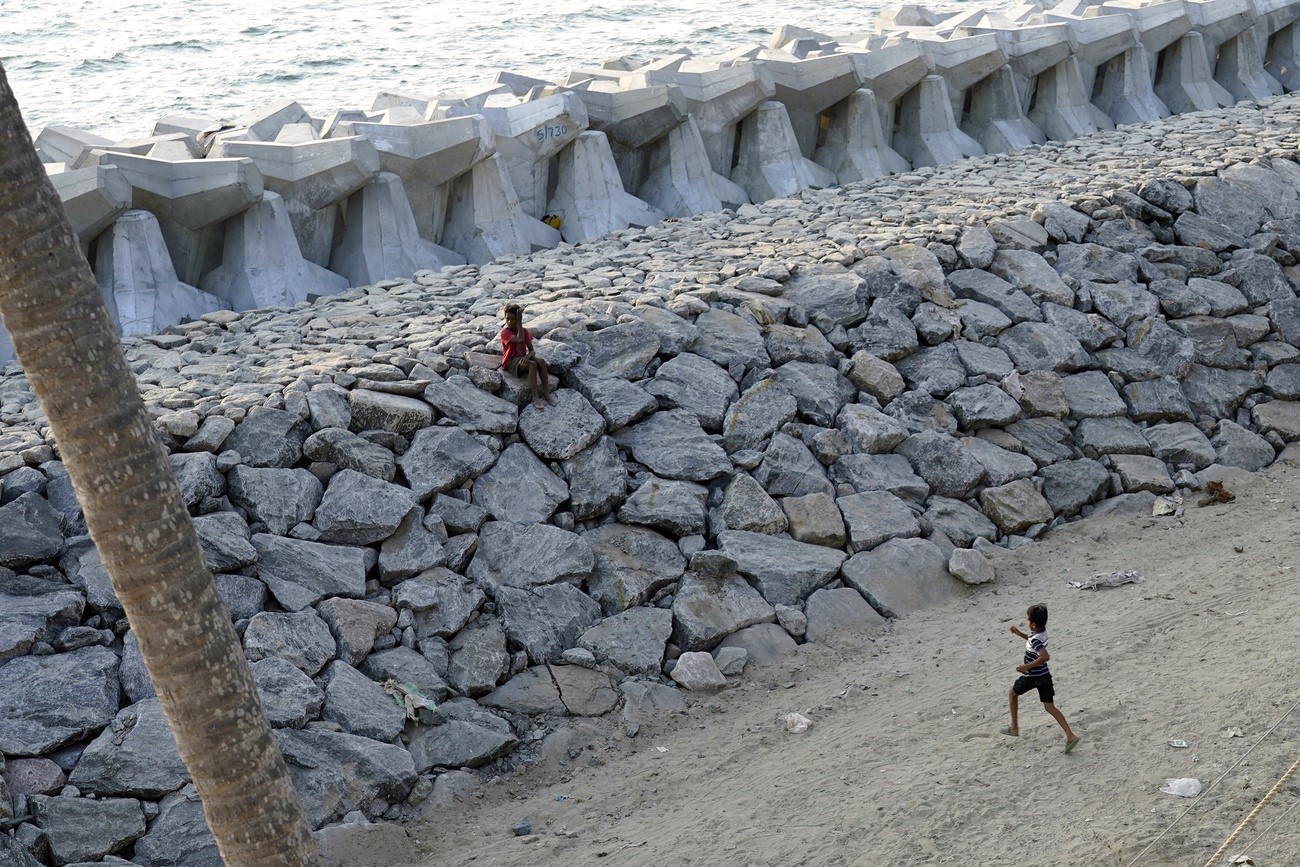 Kids play on a newly build sea wall in Kochi, Kerala state, India,