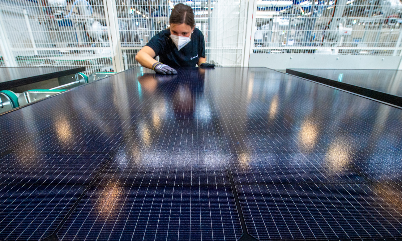 An employee inspects a solar module in the final inspection of a production line for solar modules at the Meyer Burger Technology AG plant in Freiberg.