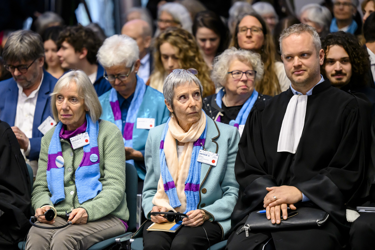 two women and a lawyer in a crowd