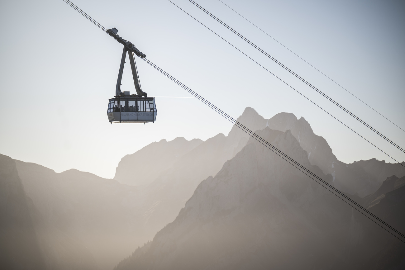 As the fog pushes down on low-laying cities in Switzerland, a cable car pushes above the clouds towards the Hoher Kasten mountain in canton Appenzell Inner Rhodes.