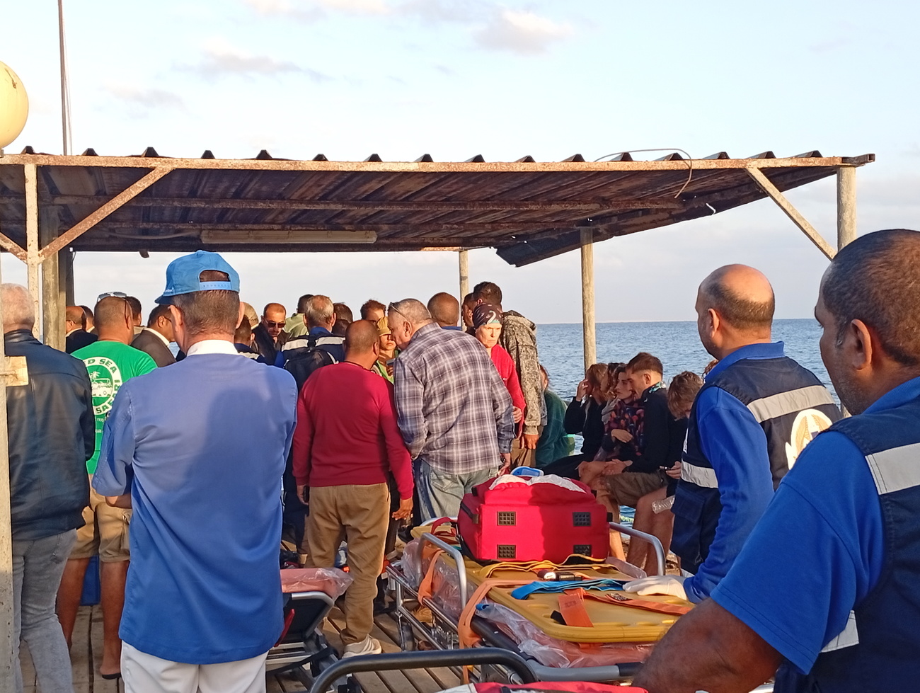 Medics and people wait for possible survivors after a boat sank at a harbour in Marsa Alam, Red Sea Governorate, in Egypt 25 Novermber 2024.