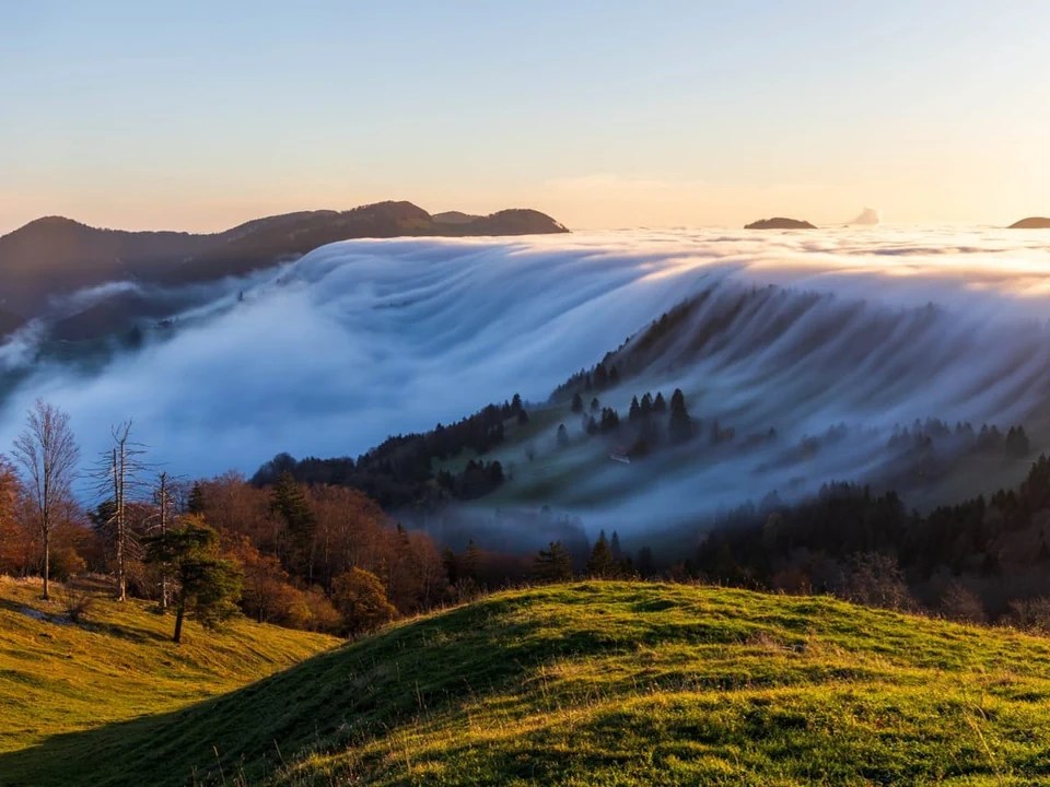 clouds rolling over a autumn hill