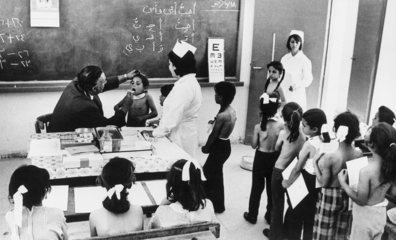 Palestinian schoolchildren in Jordan getting health check from UNRWA health workers around 1970.