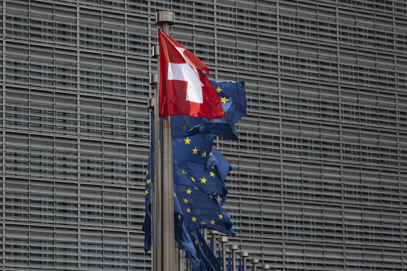 The Swiss flag flies alongside European flags in front of the headquarters of the European Commission, the Berlaymont building, during the visit of President Viola Amherd to Brussels, Belgium, on Monday, 18 March 2024. The President's visit marks the official start of negotiations between Switzerland and the EU.