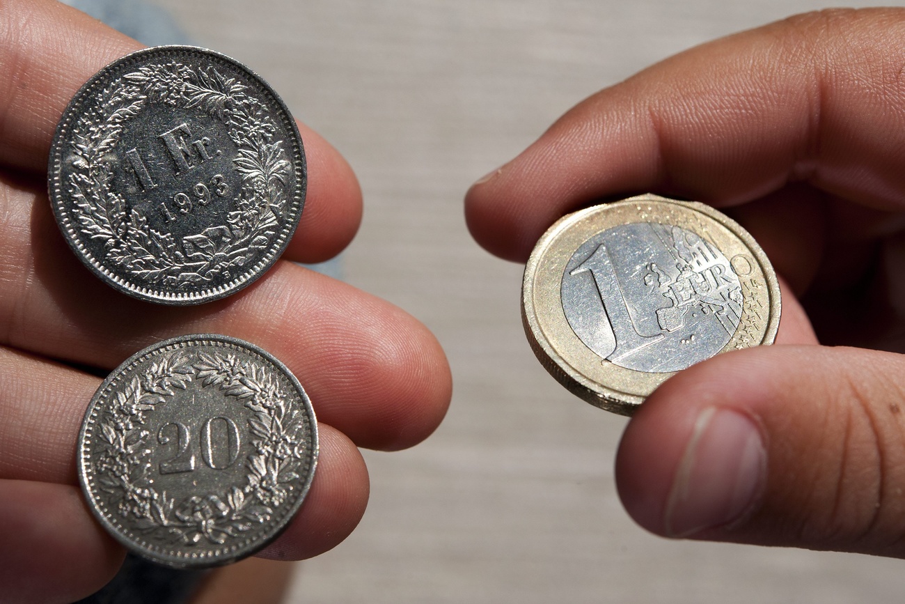 Coins of 1 Euro, right, and coins of 1 Swiss Franc and 20 centime, left, pictured in Lausanne, Switzerland, Tuesday, September 6, 2011. The Swiss National Bank SNB has decided to fix the country's exchange rate at 1.20 francs per euro. The SNB indicated it would buy an unlimited amount of euros regardless of the risk to maintain that value. (KEYSTONE/Laurent Gillieron)