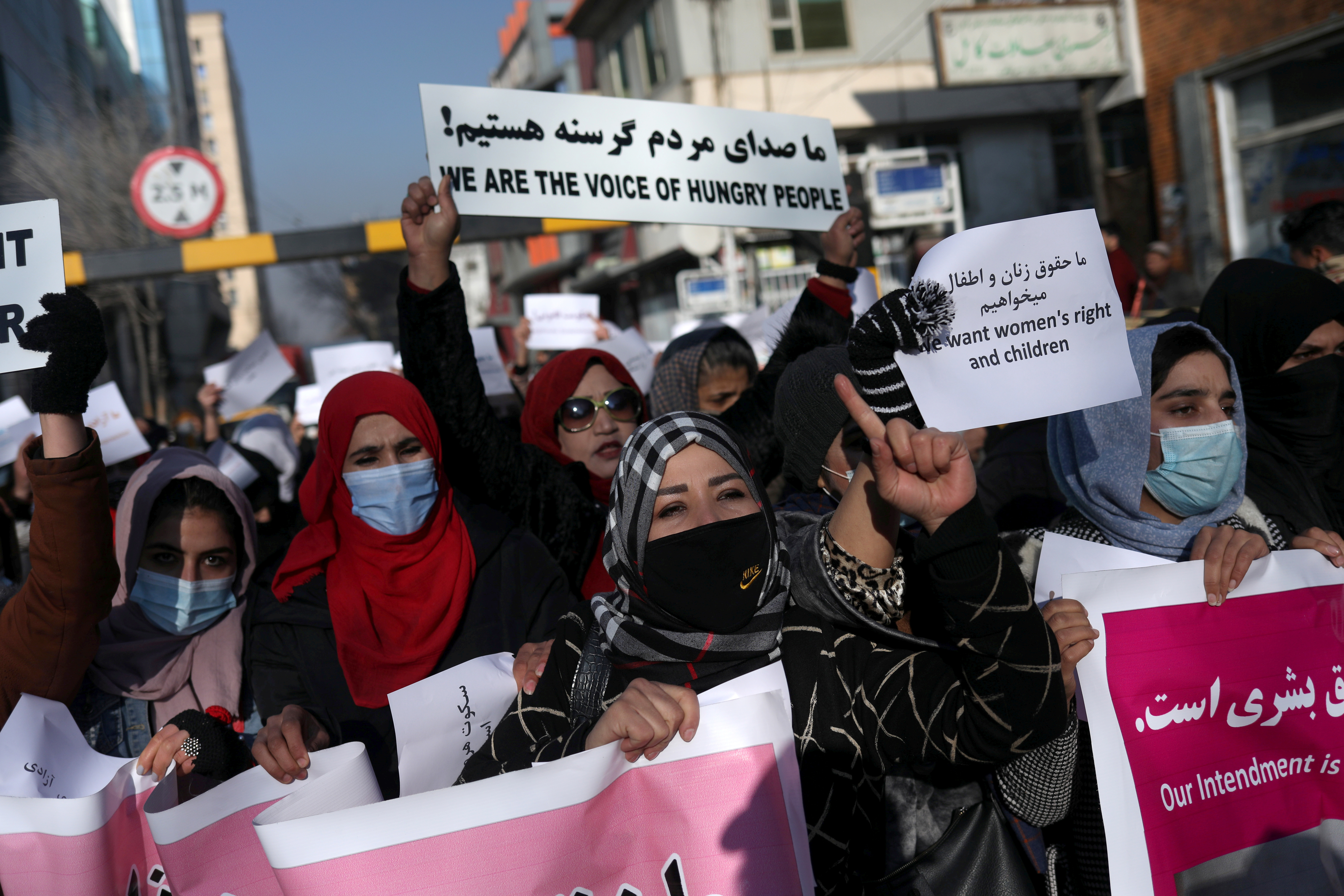 Afghan women shout slogans during a rally to protest against what the protesters say is Taliban restrictions on women, in Kabul, Afghanistan, December 28, 2021. REUTERS/Ali Khara