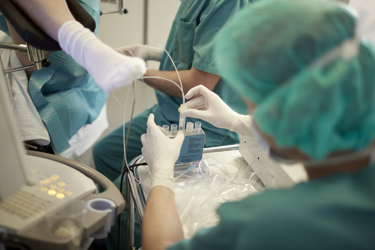 With the help of the ultrasound and a fine needle the egg cells are collected via the vagina and taken to the laboratory. The follicular fluid, which surrounds the egg cell, is collected in a test tube during the follicle puncture, pictured at the GYN-A.R.T. center for gynaecology, reproductive medicine, microsurgery, minimally invasive surgery and reproductive biology in Zurich, Switzerland,