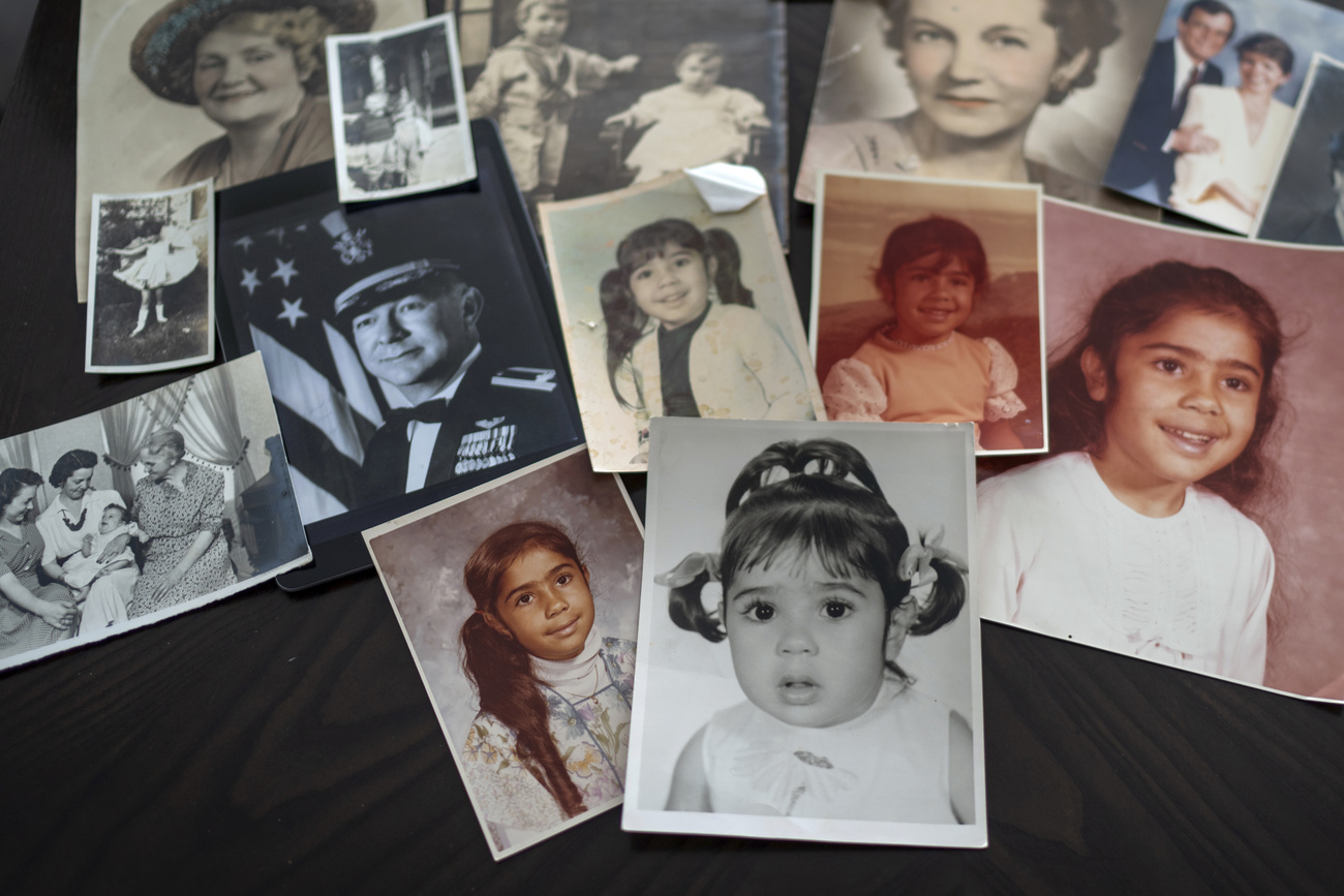 Childhood photos of Buttons are displayed along with a picture of her father, a WWII Air Force veteran, at left, and additional family photos, Monday, June 24, 2024, in Henderson, Nev. "My dad died thinking, 'I raised my daughter. I did my part,' but not knowing it put me on a path of instability and fear," she said.