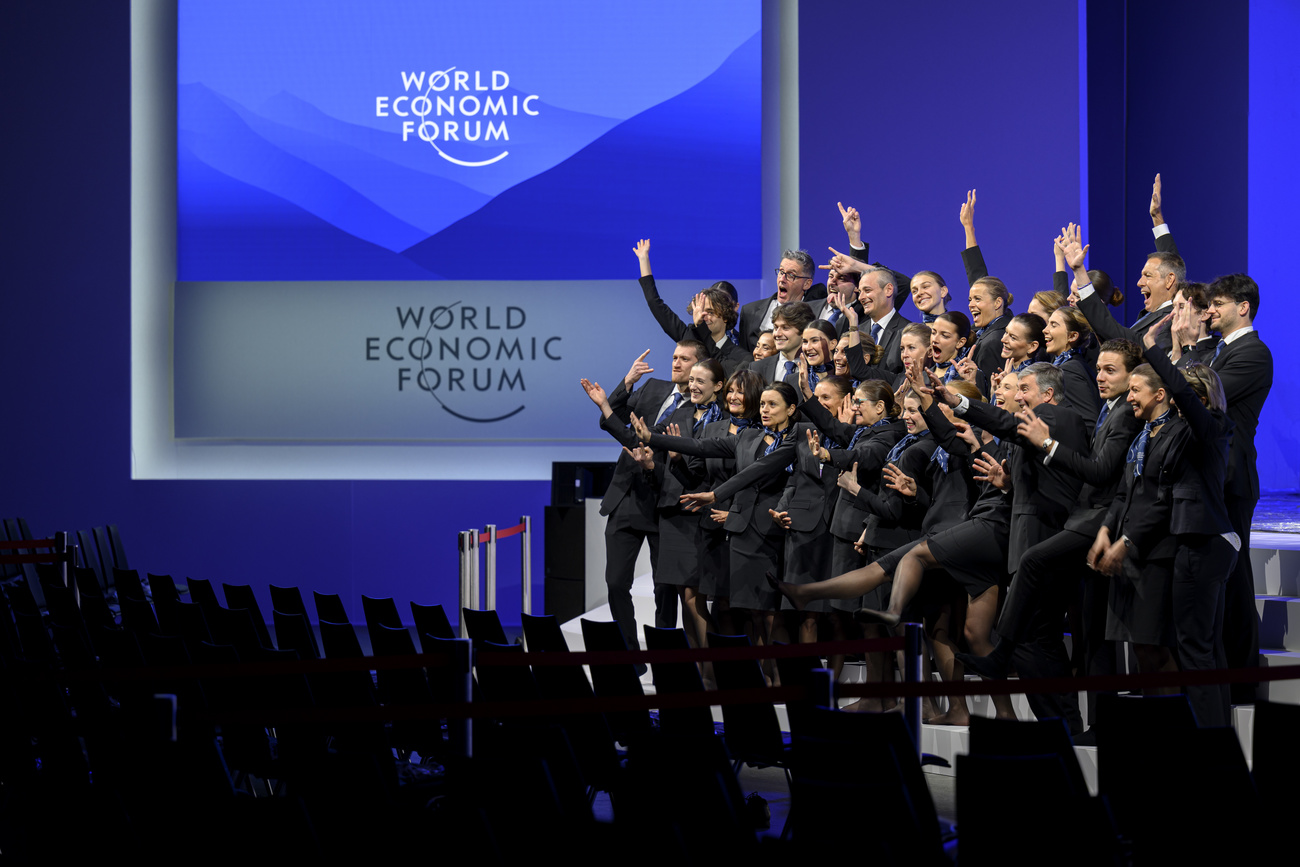 WEF's host and hostess pose for a groupe picture on the stage of the Congress Hall prior to the 55th annual meeting of the World Economic Forum, WEF, in Davos, Switzerland, Monday,