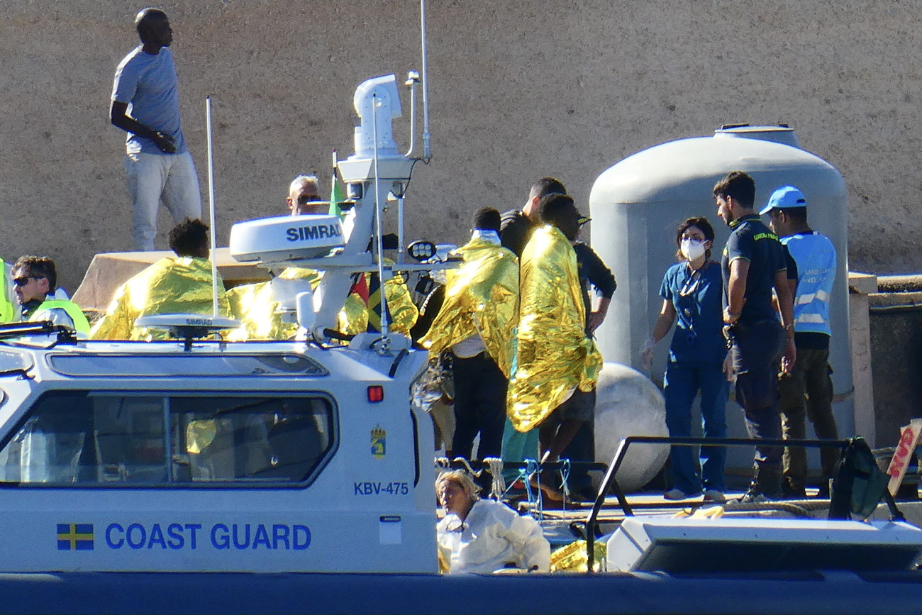 Migrants arrive aboard a Coast Guard patrol boat, after they were rescued in the waters off the island of Lampedusa, in Lampedusa, southern Italy, 11 November 2023.