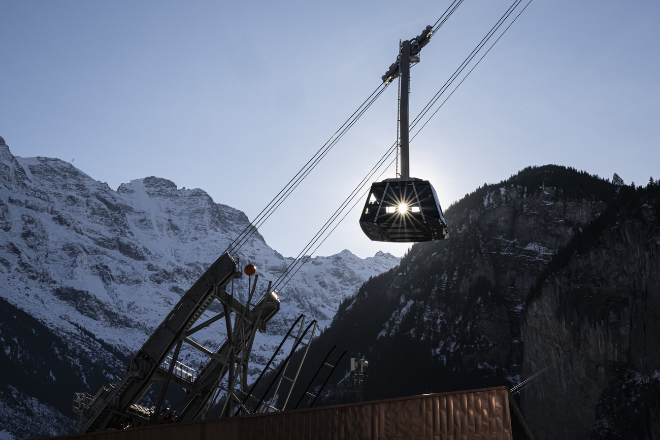 The new Schilthorn Bahn cable car cabin arrives at the departure station in Stechelberg, in the Bernese Oberland, Switzerland, on Tuesday, December 17, 2024. The newly inaugurated direct link between Stechelberg and Muerren, featuring the world's steepest aerial tramway, went into service on Saturday, December 14. With a gradient of 159.4 percent, it is officially the steepest cable car in the world. The classic aerial tramway connects the valley floor to the car-free mountain village in just four minutes, traversing the sheer cliffs of the Muerrenfluh. It ascends 775 meters over a track length of nearly 1,194 meters. (KEYSTONE/Anthony Anex)