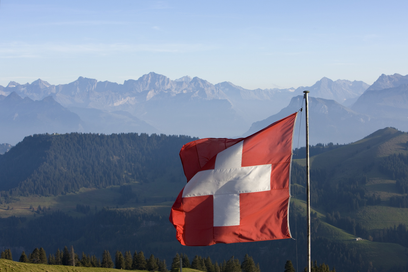 A Swiss flag blows in the wind against the backdrop of the Swiss Alps, pictured on October 3, 2009 on the Rigi mountain in Central Switzerland.