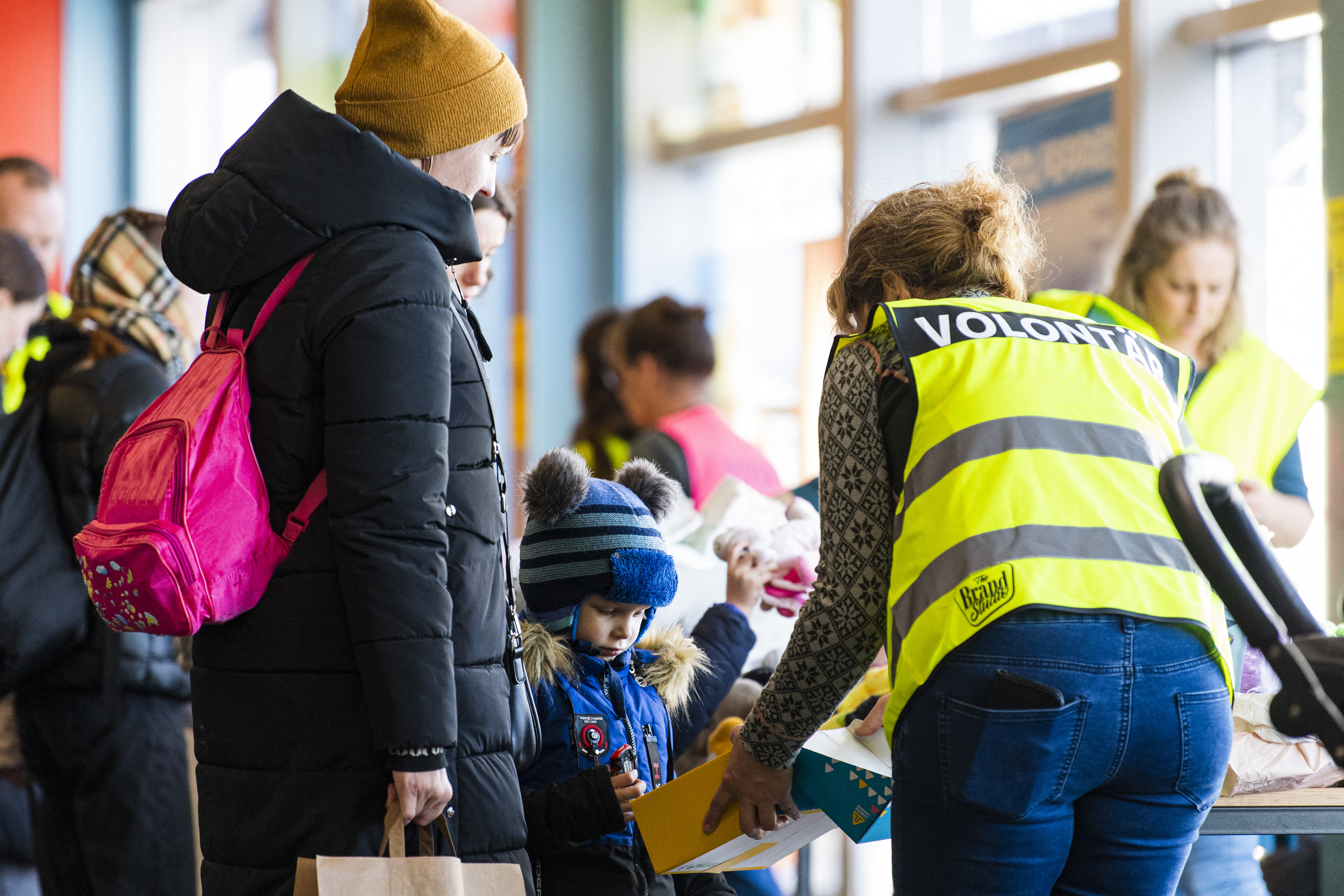 Volunteers distribute supply articles and information to Ukrainian refugees upon their arrival at a welcome and information hall in the port of Nynashamn, about 60 km south of Stockholm, Sweden, on March 15, 2022.