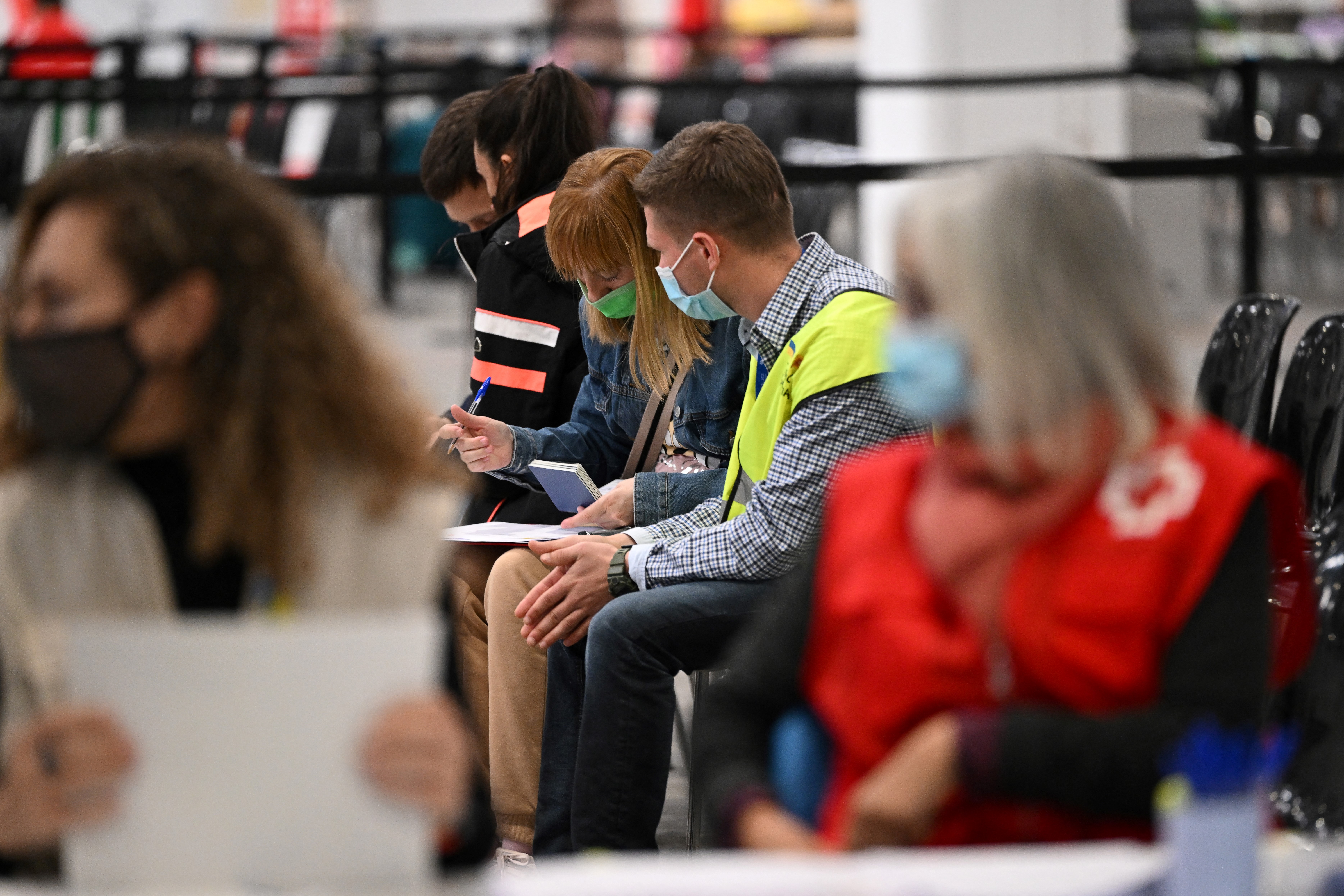 Seated volunteers at a Red Cross center in Spain