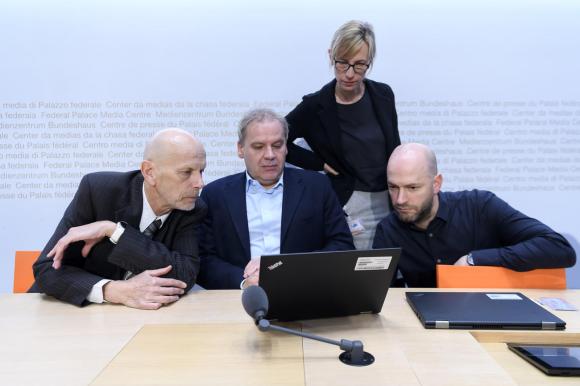 people gathering around a computer